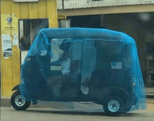 Man covers his tricycle with mosquito net to protect himself against COVID-19